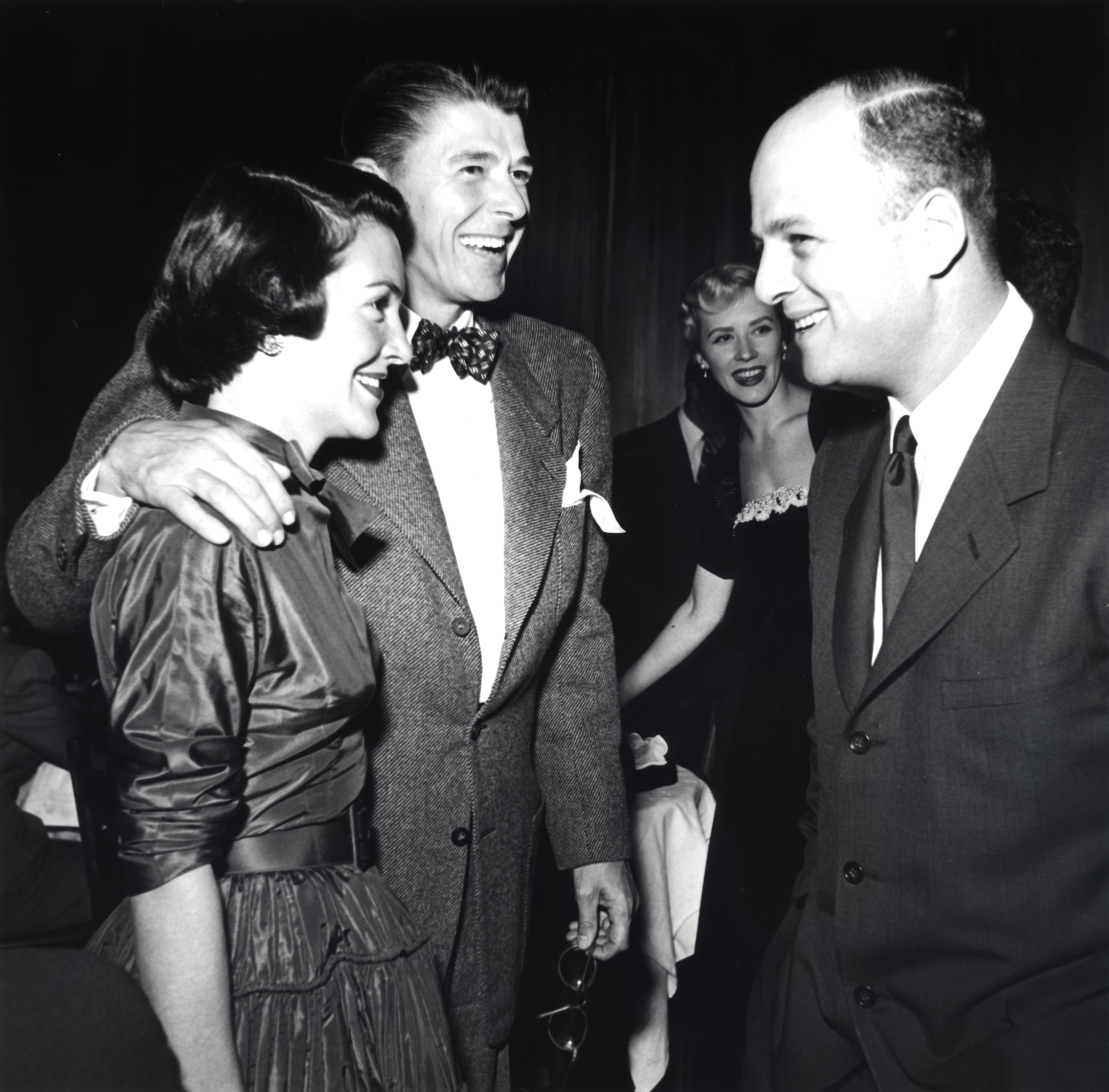 Ronald Reagan and Nancy Reagan talking to an unidentified man