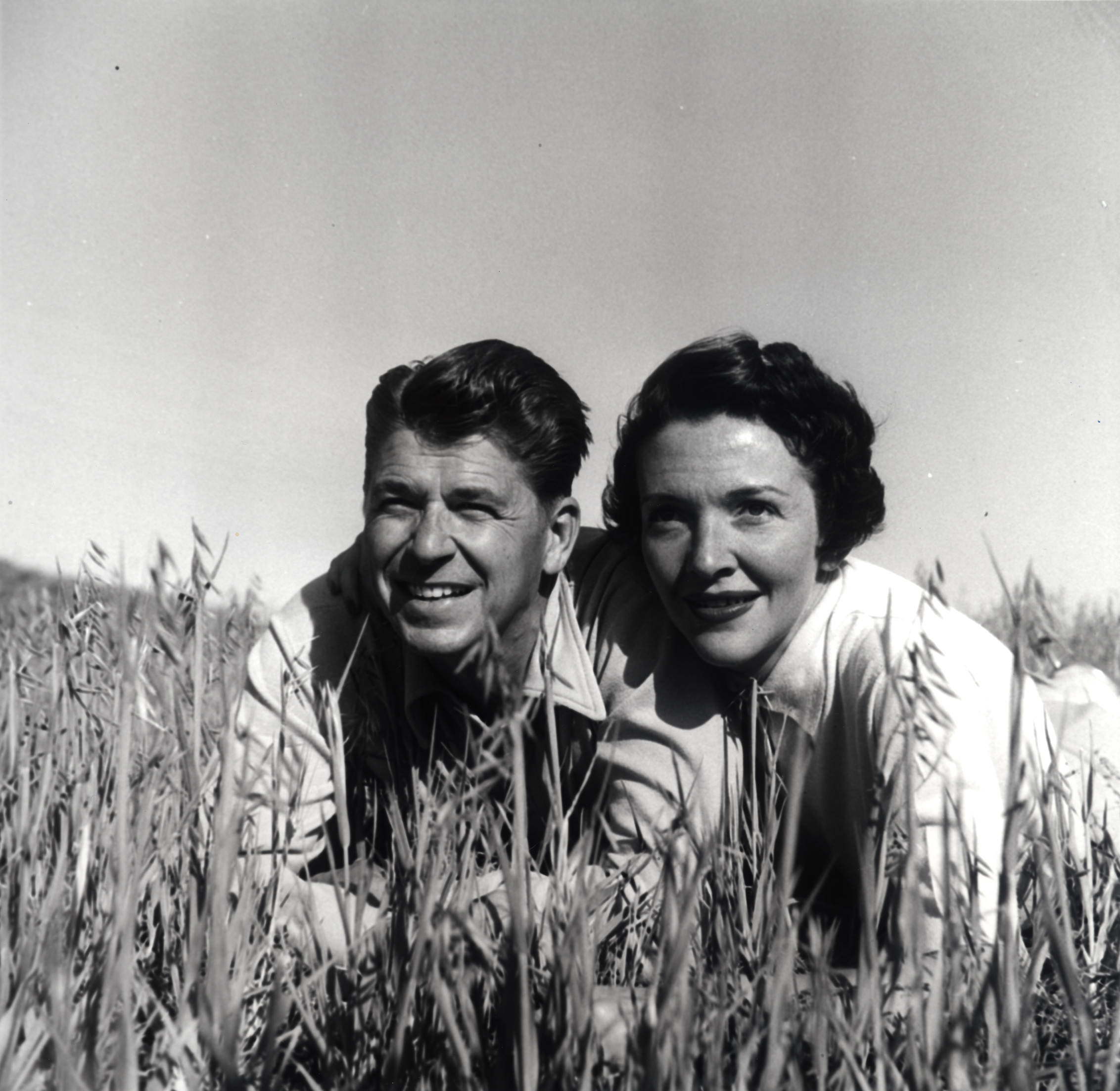Ronald Reagan and Nancy Reagan posing in the grass at their Malibu Canyon Ranch