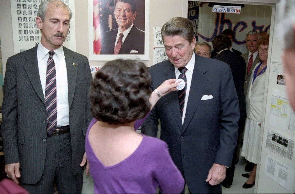 President Ronald Reagan receiving a campaign button while visiting the Reagan-Bush Campaign Headquarters in Washington, D.C. 10/31/1984