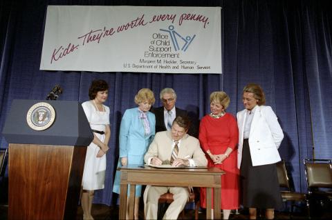 President Reagan in a Signing Ceremony for HR 4325, the Child Support Enforcement Act of 1984 in conjunction with the symposium on Child Support Enforcement, signing resolution with Mario Biaggi, Elizabeth Dole, Margaret Heckler, Marge Roukema at Sheraton Washington Hotel Washington, DC