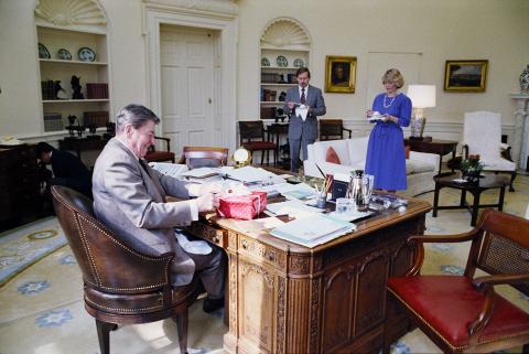 Receiving Birthday Cake and birthday card from staff members on President Reagan's 74th Birthday