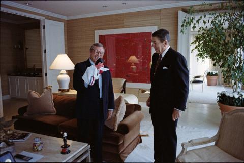 8-27-1987 Trip to California, President holding a staff meeting with Howard Baker holding a hand puppet