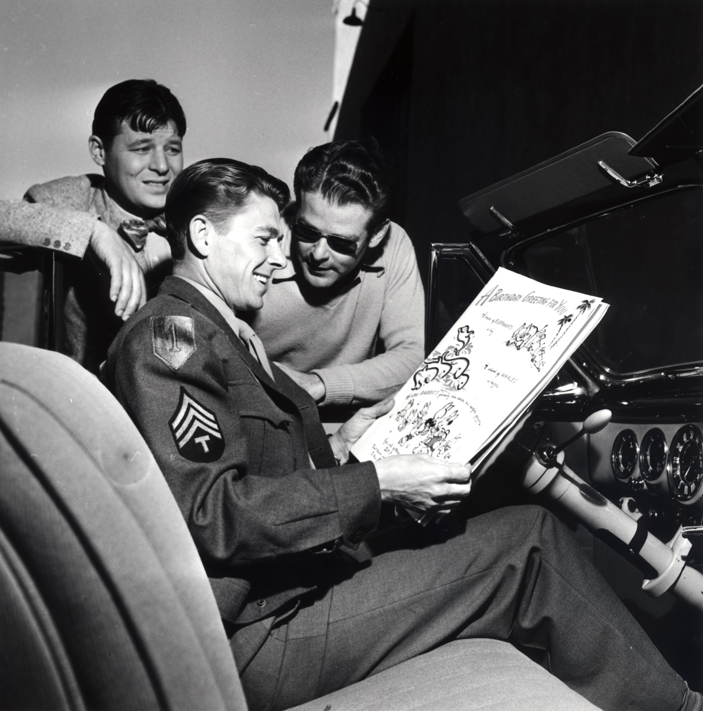 GB5.jpg Ronald Reagan, Jack Carson and an unidentified man standing near Reagan who is in a car with a large birthday card