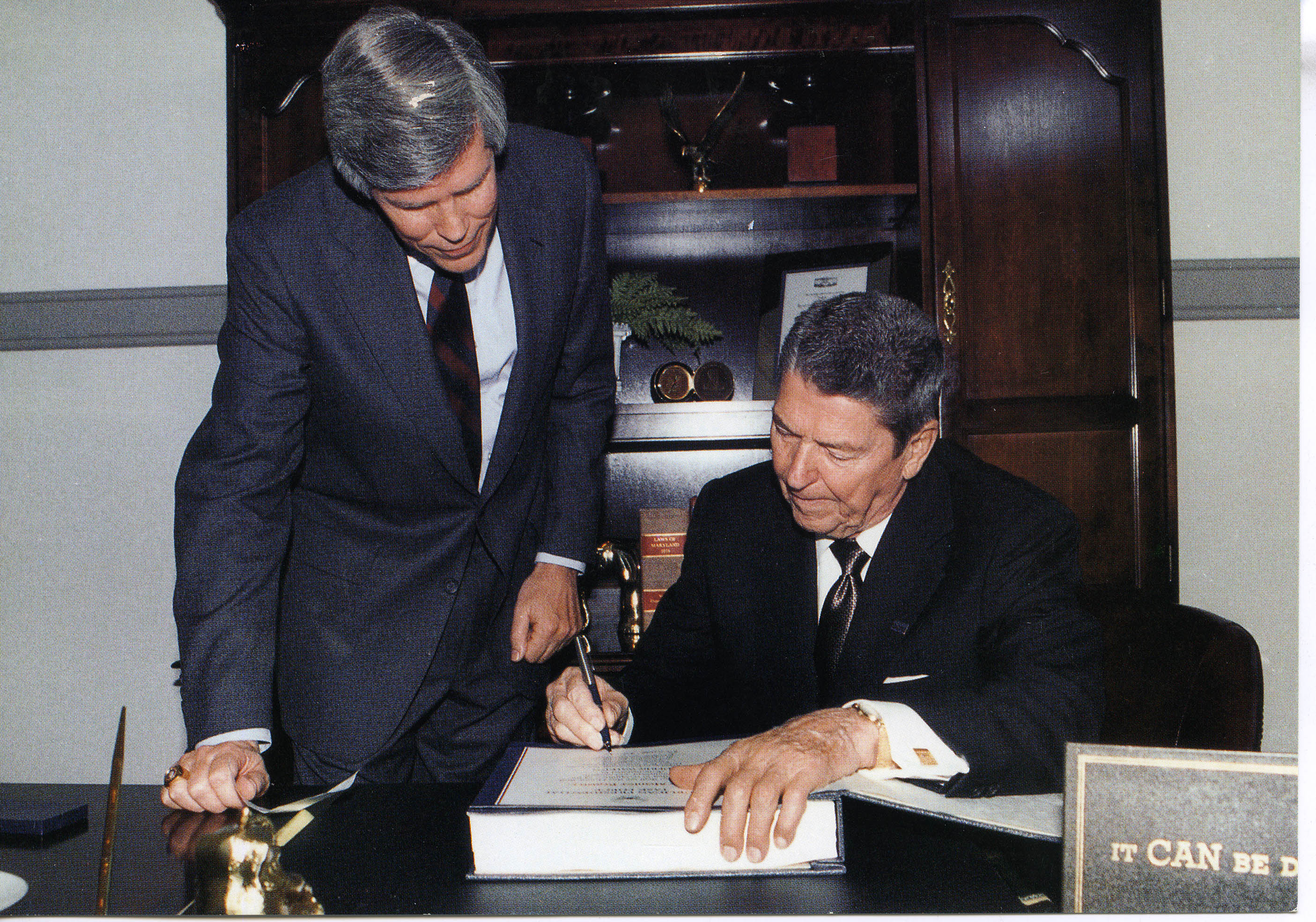 President Reagan signing unknown book