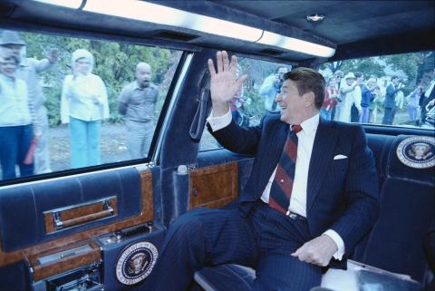 waving from limousine