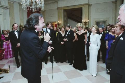 Neil Diamond singing for The Reagan's, Princess Diana and Prince Charles and other guests at a Dinner for Prince Charles and Princess Diana of the United Kingdom in the entrance hall
