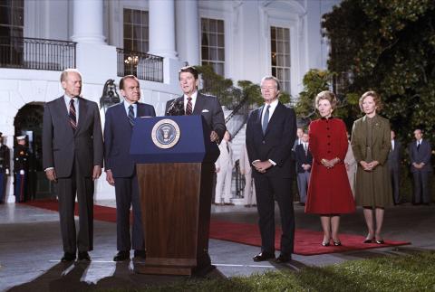 President Reagan speaking during former presidents at the White House prior to their departure for the funeral of President Sadat of the Arab Republic of Egypt