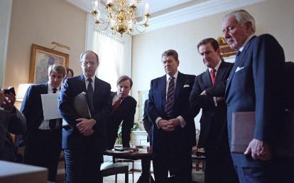 President Ronald Reagan and staff watching televised replay of the Space Shuttle Challenger explosion. Left to right: Larry Speakes, Dennis Thomas, Jim Kuhn, President Ronald Reagan, Pat Buchanan, and Donald Regan 01/28/1986  NAID: 75854569