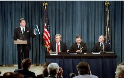 President Ronald Reagan delivering his Remarks on Receiving the Final Report of the President's Special Review Board on the National Security Council From left to right: Edmund Muskie, John Tower and Brent Scowcroft 02/26/1987  NAID: 75855307