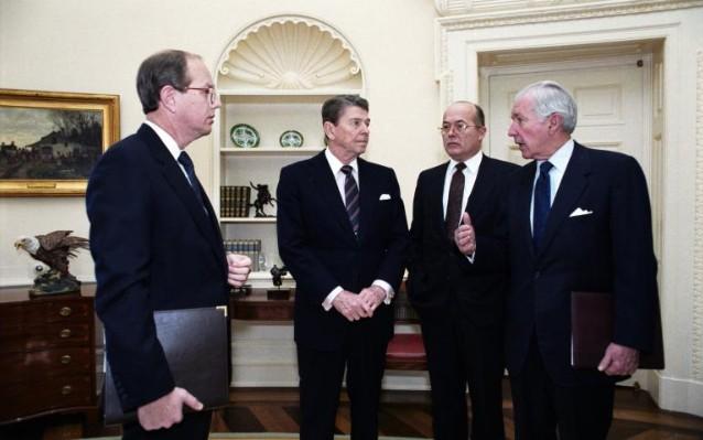 President Ronald Reagan, Assistant to the President Office of the Chief of Staff W. Dennis Thomas, Assistant to the President for National Security Affairs John Poindexter, and Chief of Staff Don Regan in the Oval Office 01/28/1986