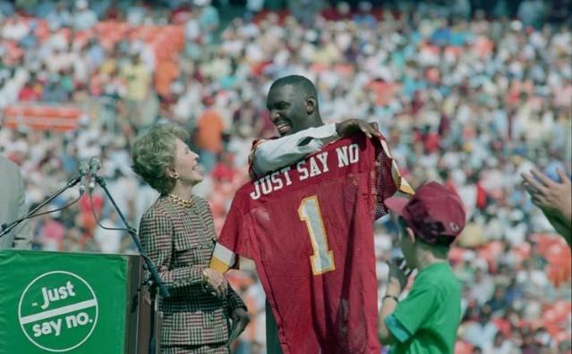 Nancy Reagan receiving a “Just Say No” jersey from Washington Redskins football player Doug Williams at an event in Robert F. Kennedy Stadium, Washington, D.C. dated 10/02/1988 NAID: 75856297