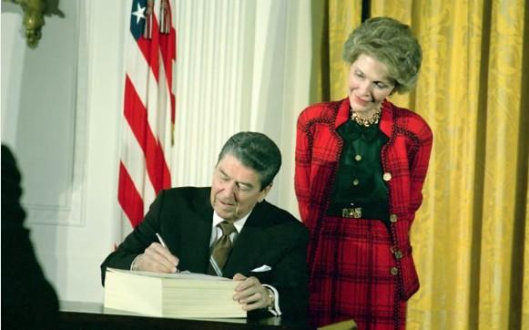 President Ronald Reagan, with Nancy Reagan, signing H.R.5210 the Anti-Drug Abuse Act of 1988 in the East Room dated 11/18/1988
