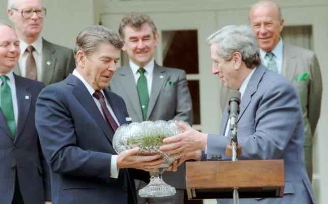 President Ronald Reagan receiving shamrocks in a Waterford crystal bowl from Prime Minister Garret FitzGerald of Ireland during a ceremony in the Rose Garden 03/17/1986 