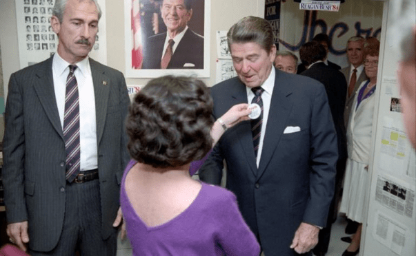 President Ronald Reagan receiving a campaign button while visiting the Reagan-Bush Campaign Headquarters in Washington, D.C. 10/31/1984 