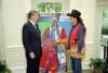 President Ronald Reagan with contemporary artist John Nieto in the Oval Office being presented with the painting Delegate to the White House 08/05/1982  NAID: 75856951