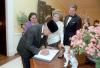 President Suharto of Indonesia signing the guestbook in the residence as Siti Hartinah Suharto, Nancy Reagan, and President Ronald Reagan look on 10/12/1982 NAID: 75852461