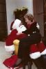 Nancy Reagan sits on Santa Claus’ (President Ronald Reagan) lap at a Christmas Eve party at the Wick residence in Washington, D.C. 12/24/1983  NAID: 75853187