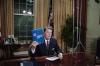 President Ronald Reagan holding up a copy of Report of the President’s Special Review Board during his Address to the Nation on the Iran Arms and Contra Aid Controversy and Administration Goals in the Oval Office 08/12/1987 