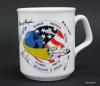 Challenger Coffee Cup Artifact ID: 1986.30895.01 Object Name: Mug, Coffee Date Made: 1986 Description: A white ceramic coffee mug with an image of the Space Shuttle Challenger flying around the Earth and over the American flag. Surrounding the image are facsimile signatures of the crew members and their last names printed: Michael J. Smith, Judith A. Resnik, Ronald E. McNair, Ellison S. Onizuka, Gregory B. Jarvis, and Christa McAuliffe." The bottom of the mug is stamped "MADE IN ENGLAND."