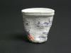 [View 4 of 5] Shrunken Challenger Coffee Cup Artifact ID: 1986.31470.01 Maker: Roger W. Cook, Director, Marine Operations, Harbor Branch Foundation Inc., Fort Pierce, Florida Date Made: 1986 Label Text: This cup was placed in the battery compartment of the submersible used by the donor's company to search for the Space Shuttle Challenger. The size of the cup was reduced under pressure at 1284 Ft.