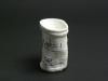 [View 5 of 5] Shrunken Challenger Coffee Cup Artifact ID: 1986.31470.01 Maker: Roger W. Cook, Director, Marine Operations, Harbor Branch Foundation Inc., Fort Pierce, Florida Date Made: 1986 Label Text: This cup was placed in the battery compartment of the submersible used by the donor's company to search for the Space Shuttle Challenger. The size of the cup was reduced under pressure at 1284 Ft.
