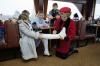 Nancy Reagan signing a cast during a boat tour to St. Prex during trip to Switzerland, 11/19/1985