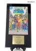 A copy of The New Teen Titans comic book on a plaque with a brass plate stating, "Presented to Nancy Reagan by Keebler Company and DC Comics in recognition of your efforts to combat drug abuse among the young people of America." 