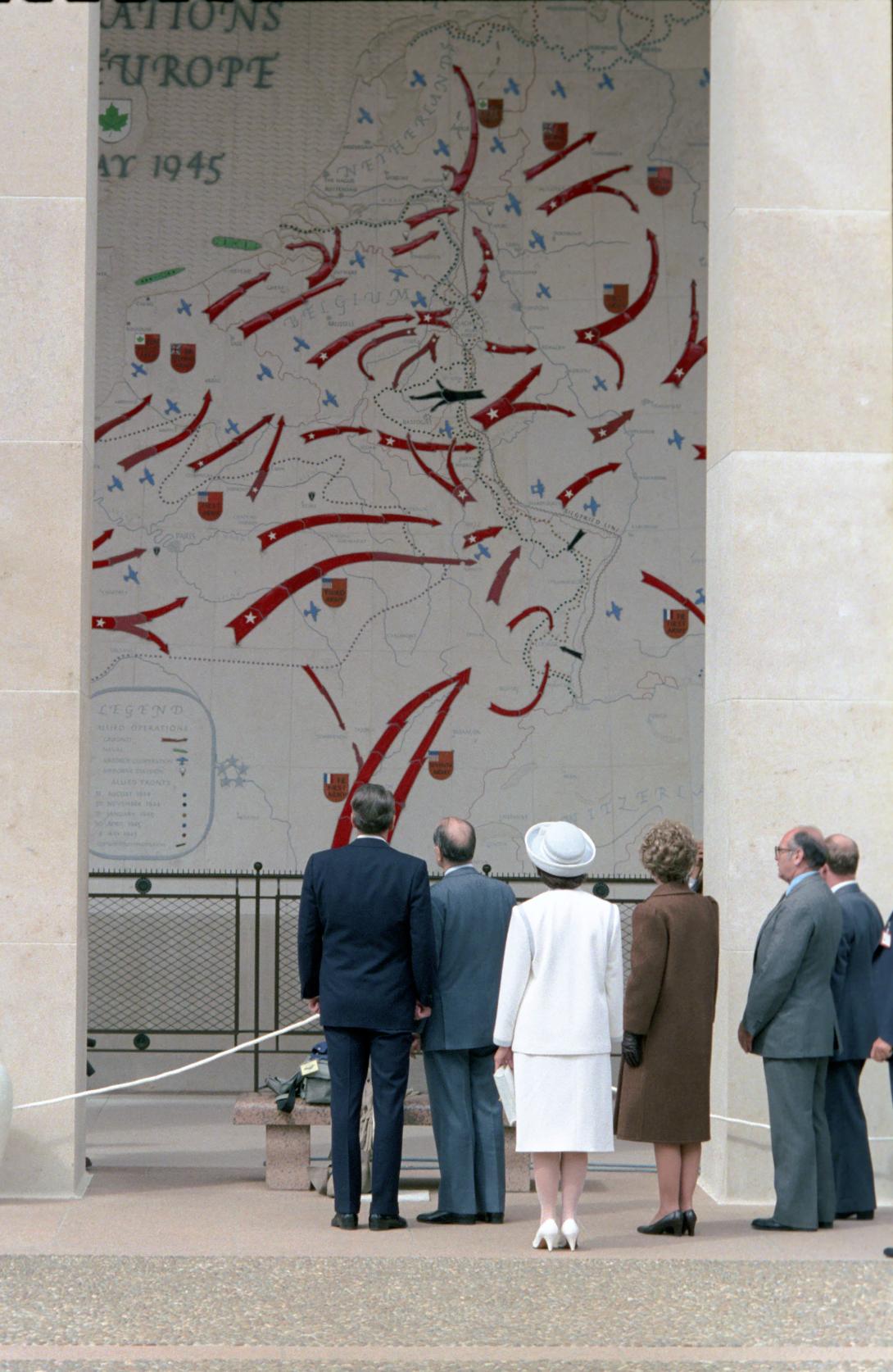 President Reagan, President Francois Mitterrand, Nancy Reagan, and Danielle Mitterrand viewing map at Omaha Beach Cemetery