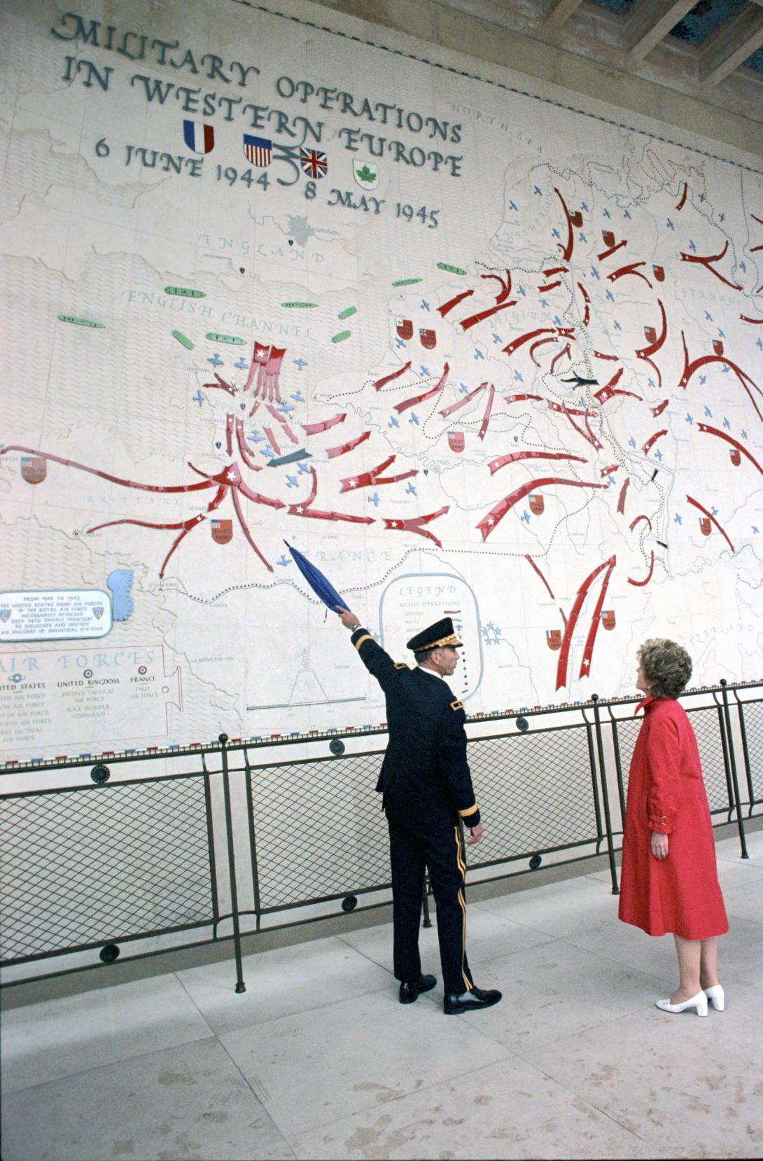 Nancy Reagan with group looking at map of Military Operations in  Western Europe.