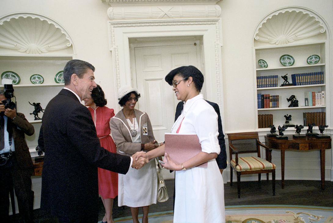 President Ronald Reagan greeting Special Assistant to the President for Blacks and Youth Thelma Duggin during a meeting to discuss the 72nd Annual Convention of the National Association for Advancement of Colored People (NAACP) in the Oval Office 06/23/1981  NAID: 404525201
