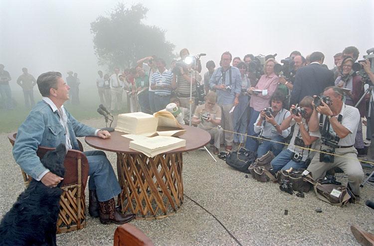 President Ronald Reagan speaking with the press with Millie by his side at Rancho del Cielo during the signing of the Economic Recovery Tax Act of 1981 and the Omnibus Budget Reconciliation Act of 1981 08/13/1981  NAID: 75854785