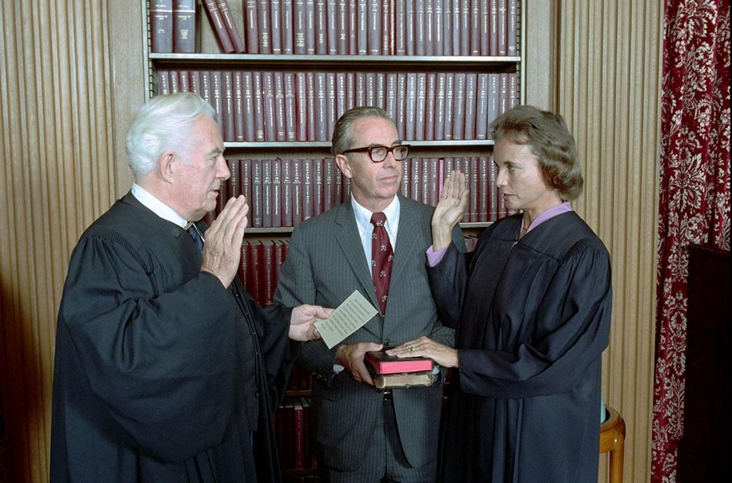 Sandra Day O’Connor being sworn in as Supreme Court Justice by Chief Justice Warren Burger with her husband John O’Connor looking on at the U.S. Supreme Court 09/25/1981 NAID: 276563289