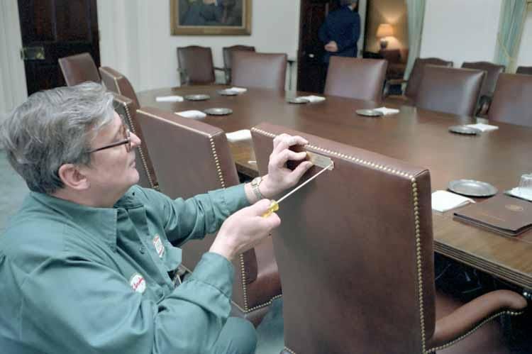Glen Carrington attaching a new nameplate on President Ronald Reagan’s chair in the Cabinet Room 01/20/1981NAID: 75852833