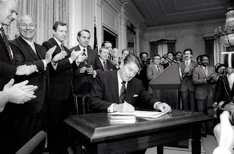 President Ronald Reagan signing the Voting Rights Act Amendments of 1982 in the East Room 06/29/1982 (as enacted H.R. 3112 is Public Law 97-205) 06/29/1982  NAID: 276563489