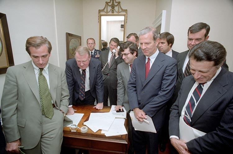 President Ronald Reagan watching the tax bill vote on television with staff in the White House 08/19/1982  NAID: 75856979