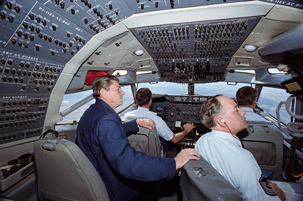 President Ronald Reagan sitting with the crew in the cockpit of Air Force One 03/16/1982  NAID: 75856677