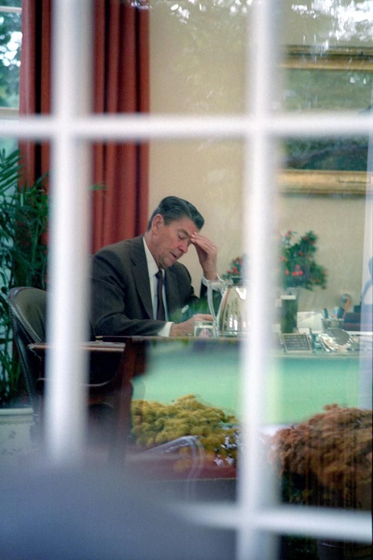 President Ronald Reagan drafting his Address to the Nation on the Events in Lebanon and Grenada in the Oval Office 10/27/1983  NAID: 75853085