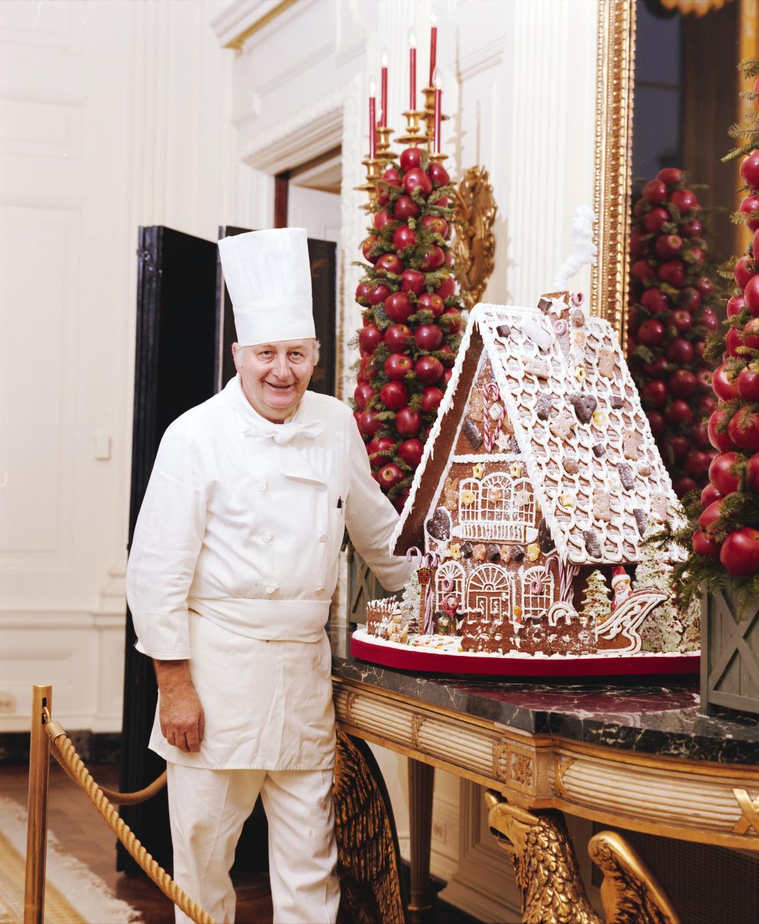 Chef Hans Raffert posing with the gingerbread house 12/13/1983 