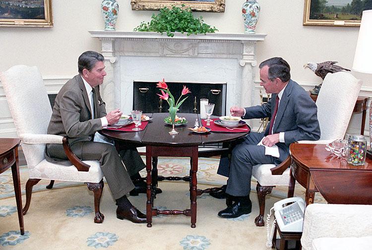 President Ronald Reagan and Vice President George Bush in the Oval Office having their regular Thursday lunch 05/03/1984 NAID: 75853359