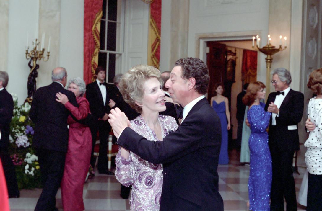 Nancy Reagan and designer James Galanos dancing during the state dinner for President François Mitterrand of France in the East Room 03/22/1984  NAID: 276563817
