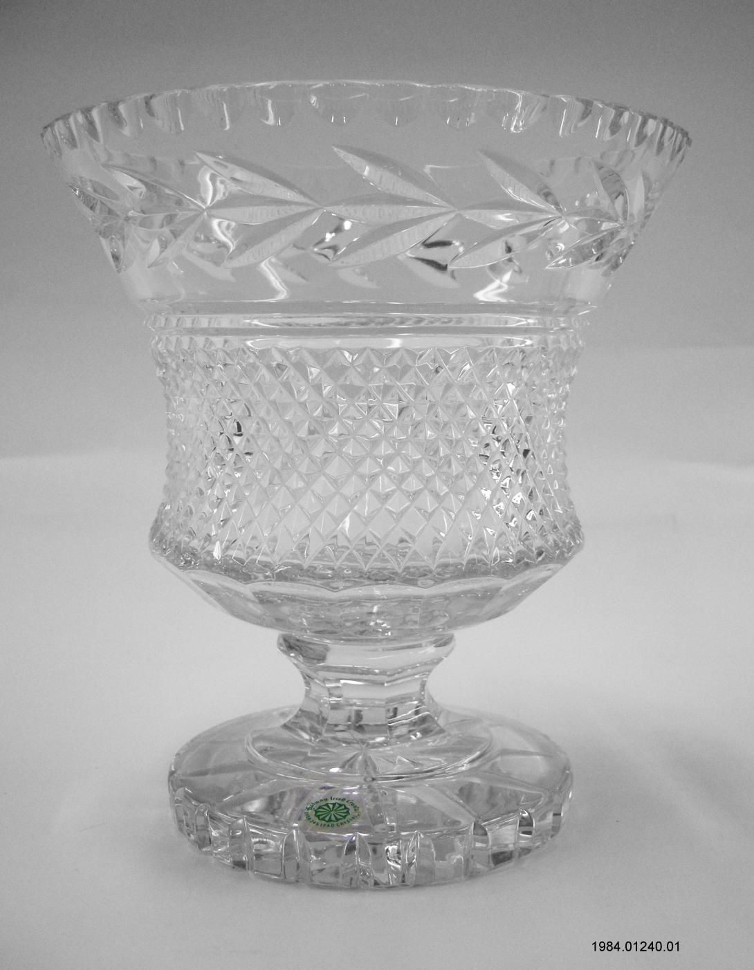 A compote style crystal glass vase by Galway Irish Crystal. Prime Minister Garret FitzGerald of Ireland traveled to Washington, D.C. for an official working visit March 14-16, 1984. During the White House luncheon on March 16, he presented this vase with the traditional shamrocks to President Ronald Reagan. Artifact ID: 1984.01240.01