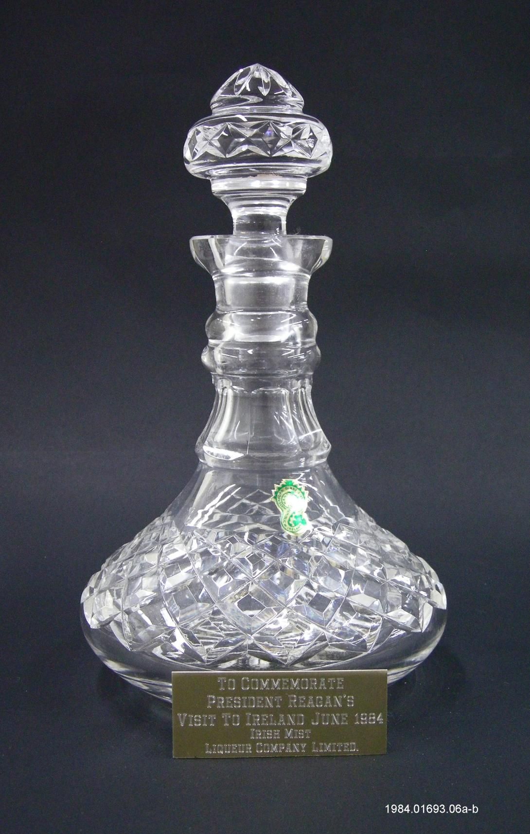 Waterford crystal decanter, which was filled with Irish Mist whiskey, traces of whiskey are still in the bottom. The plaque reads “TO COMMEMORATE PRESIDENT REAGAN’S VISIT TO IRELAND JUNE 1984 IRISH MIST LIQUEUR COMPANY LIMITED.” It was given during a trip to Ireland June 1-4, 1984. Gifter: Mayor Michael Leahy of Galway, Ireland. Artifact ID: 1984.01693.06a-c