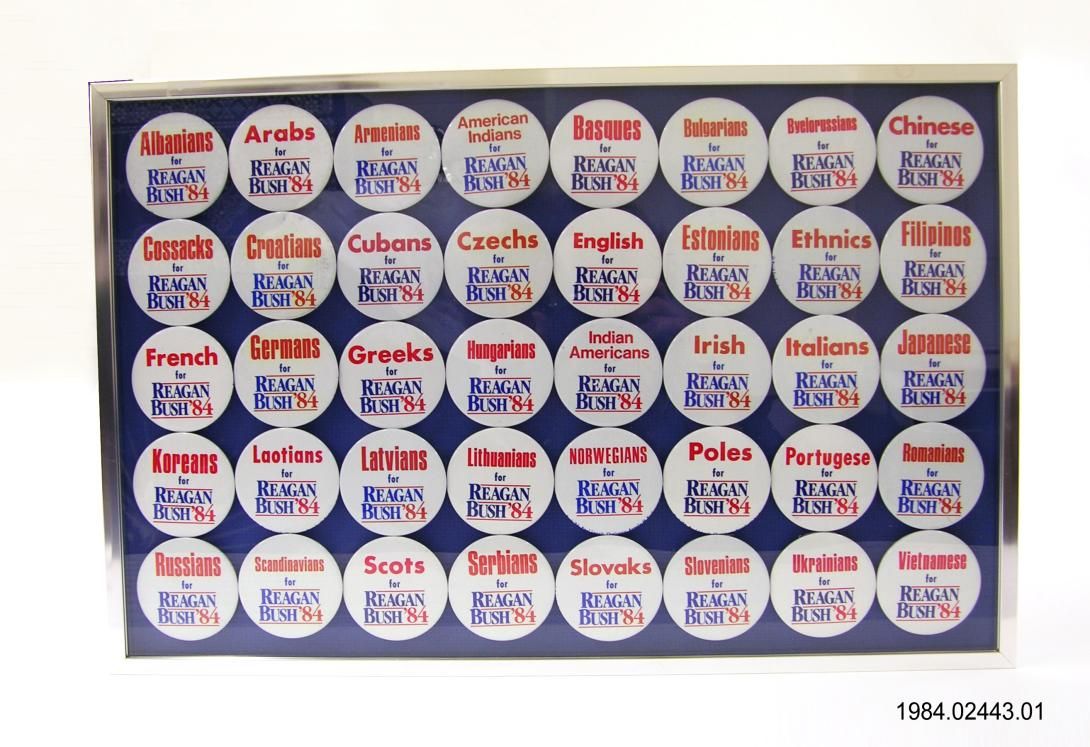 Forty framed campaign buttons stating "[Insert Racial Identity] for Reagan Bush."   