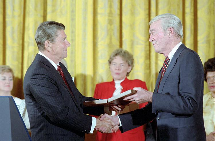 President Ronald Reagan presenting the Presidential Medal of Freedom to actor, and pilot during World War II and rising to colonel in the Eighth Air Force James “Jimmy” Stewart in the East Room 05/23/1985  NAID: 75854125