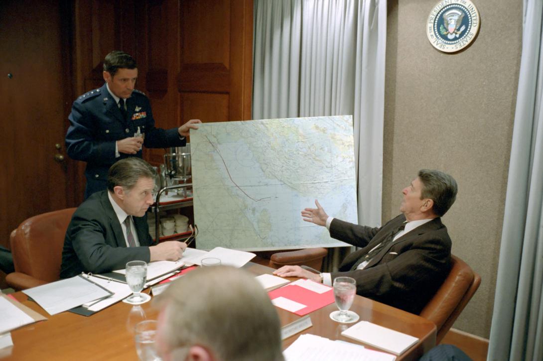 President Ronald Reagan talking to General Robert Herres during a National Security Planning Group meeting on the U.S.S. Stark attack in the White House Situation Room 05/18/1987 NAID: 75855453