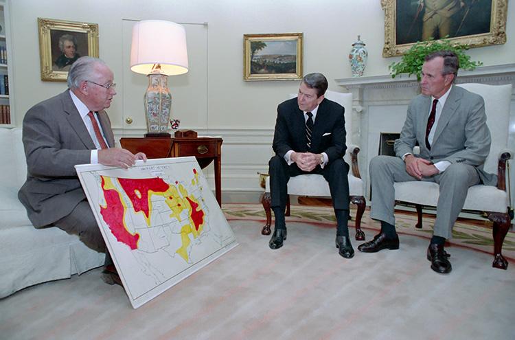 President Ronald Reagan and Vice President George Bush meeting with Secretary of Agriculture Richard Lying to discuss the status of the drought situation in the Oval Office 06/17/1988  NAID: 75856165