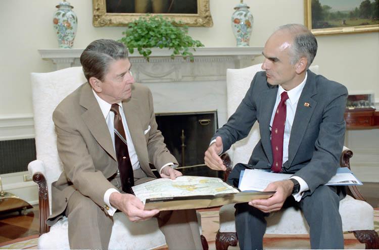 President Ronald Reagan listening to Secretary of Interior Donald Hodel during a briefing on the Yellowstone forest fire in the Oval Office 08/01/1988  NAID: 75856221