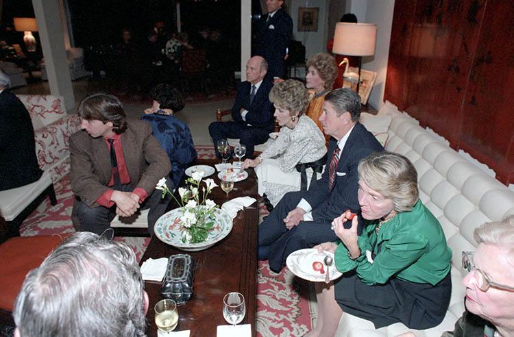 President Ronald Reagan, Nancy Reagan, Ron Reagan, and Doria Reagan watching the election results at a private dinner at the Jorgensen residence in Los Angeles, California, 11/06/1984 
