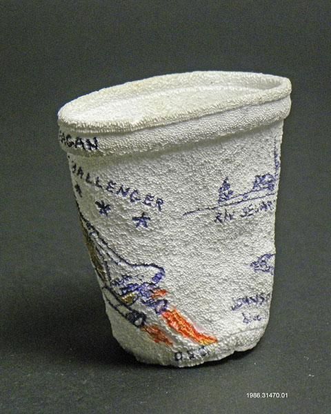 [View 3 of 5] Shrunken Challenger Coffee Cup Artifact ID: 1986.31470.01 Maker: Roger W. Cook, Director, Marine Operations, Harbor Branch Foundation Inc., Fort Pierce, Florida Date Made: 1986 Label Text: This cup was placed in the battery compartment of the submersible used by the donor's company to search for the Space Shuttle Challenger. The size of the cup was reduced under pressure at 1284 Ft.