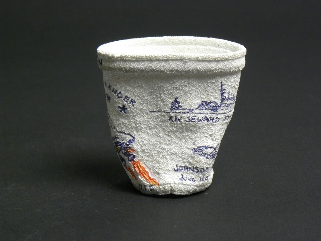 [View 4 of 5] Shrunken Challenger Coffee Cup Artifact ID: 1986.31470.01 Maker: Roger W. Cook, Director, Marine Operations, Harbor Branch Foundation Inc., Fort Pierce, Florida Date Made: 1986 Label Text: This cup was placed in the battery compartment of the submersible used by the donor's company to search for the Space Shuttle Challenger. The size of the cup was reduced under pressure at 1284 Ft.